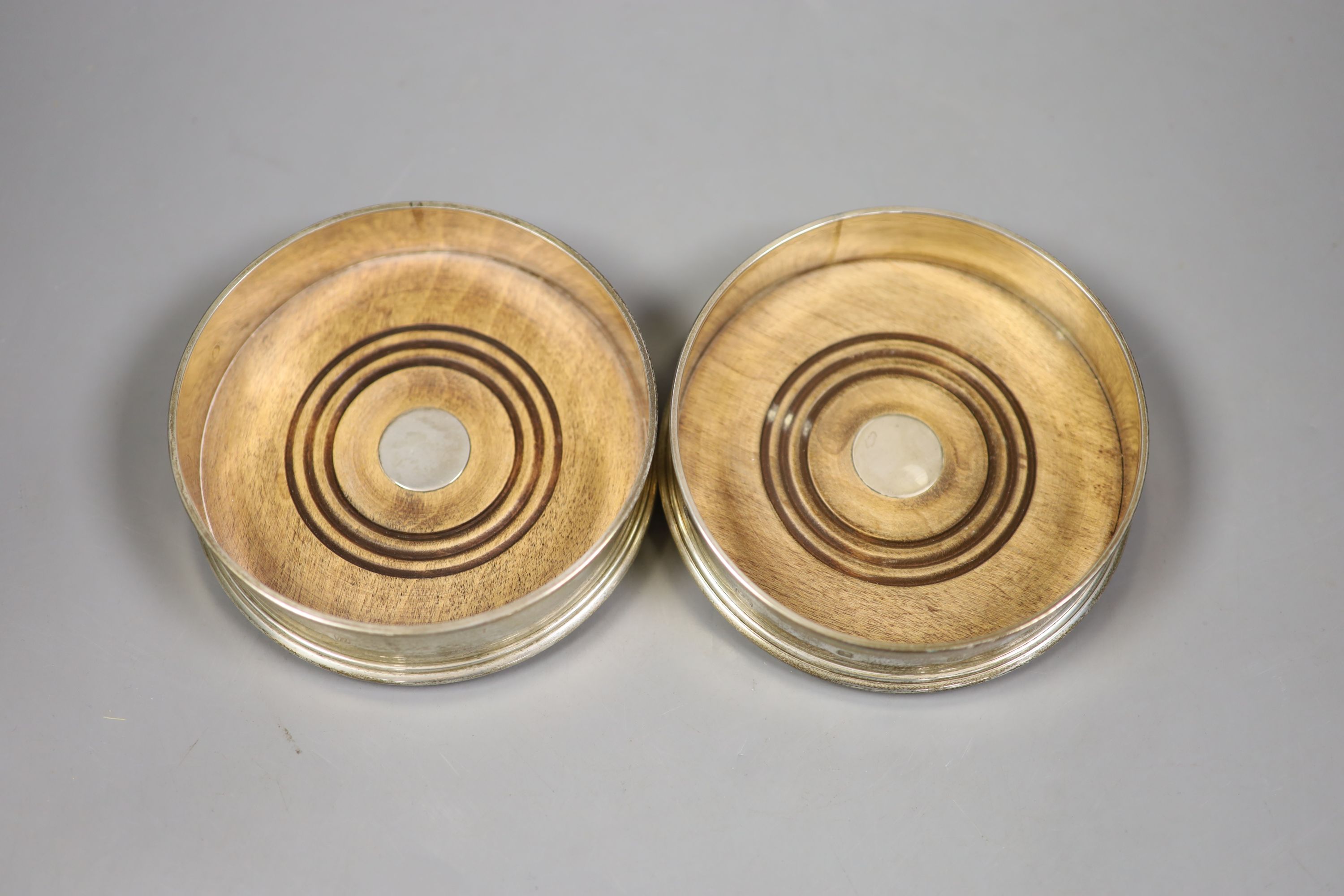 A pair of modern silver bottle coasters